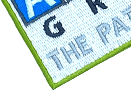 Close-up of Artex Group logo patch with green border, showcasing 'The Patch People' slogan for custom embroidered patches.