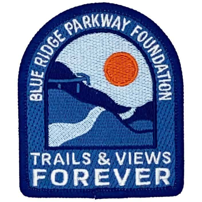 Blue Ridge Parkway Foundation patch with mountain landscape and sun, promoting 'Trails & Views Forever' for conservation and outdoor enthusiasts