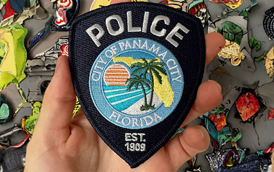 City of Panama City Police patch, featuring Florida palm trees, ocean sunset, and established date of 1909, representing local law enforcement pride.